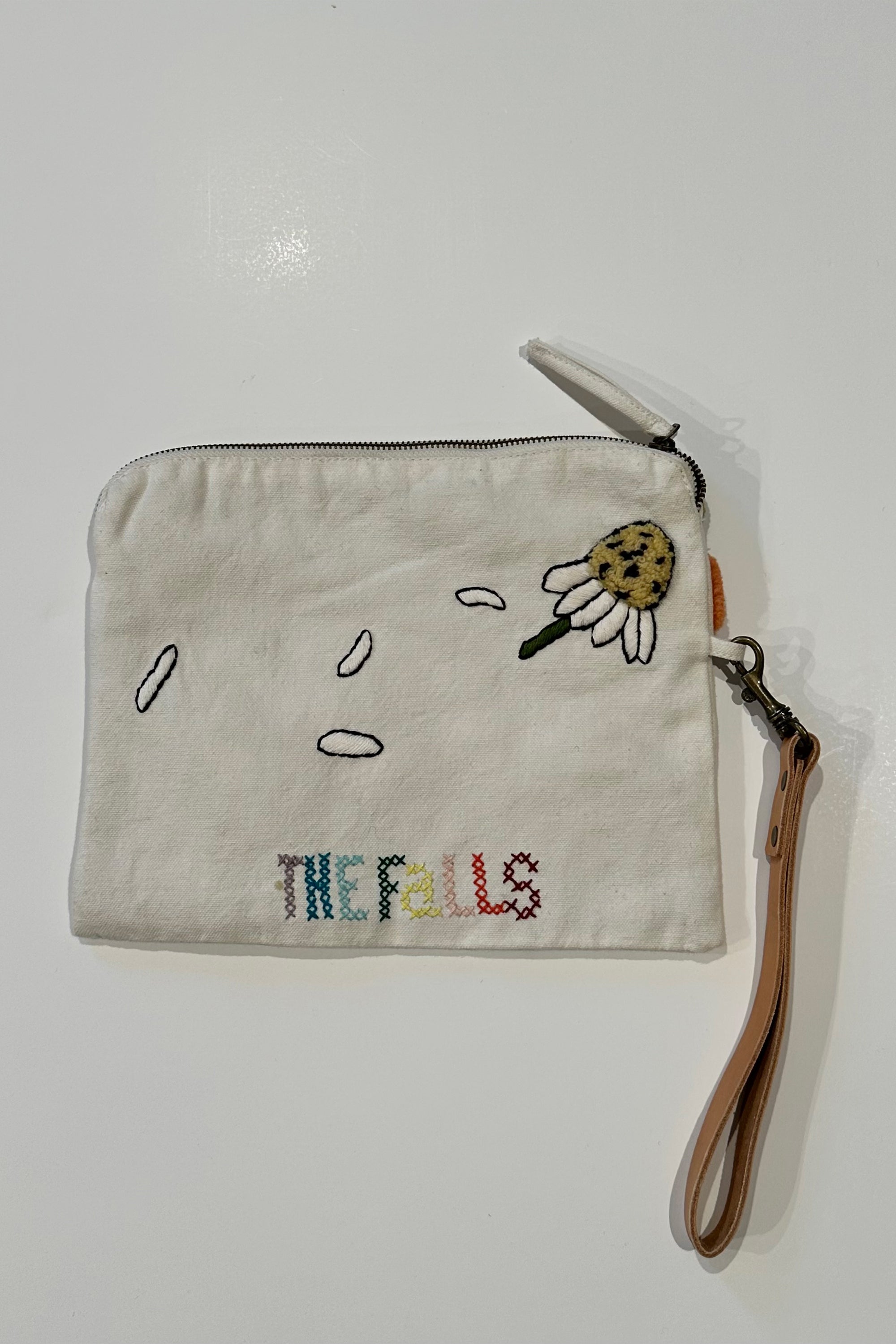 Pouch with embroidered and button embellishments, back view