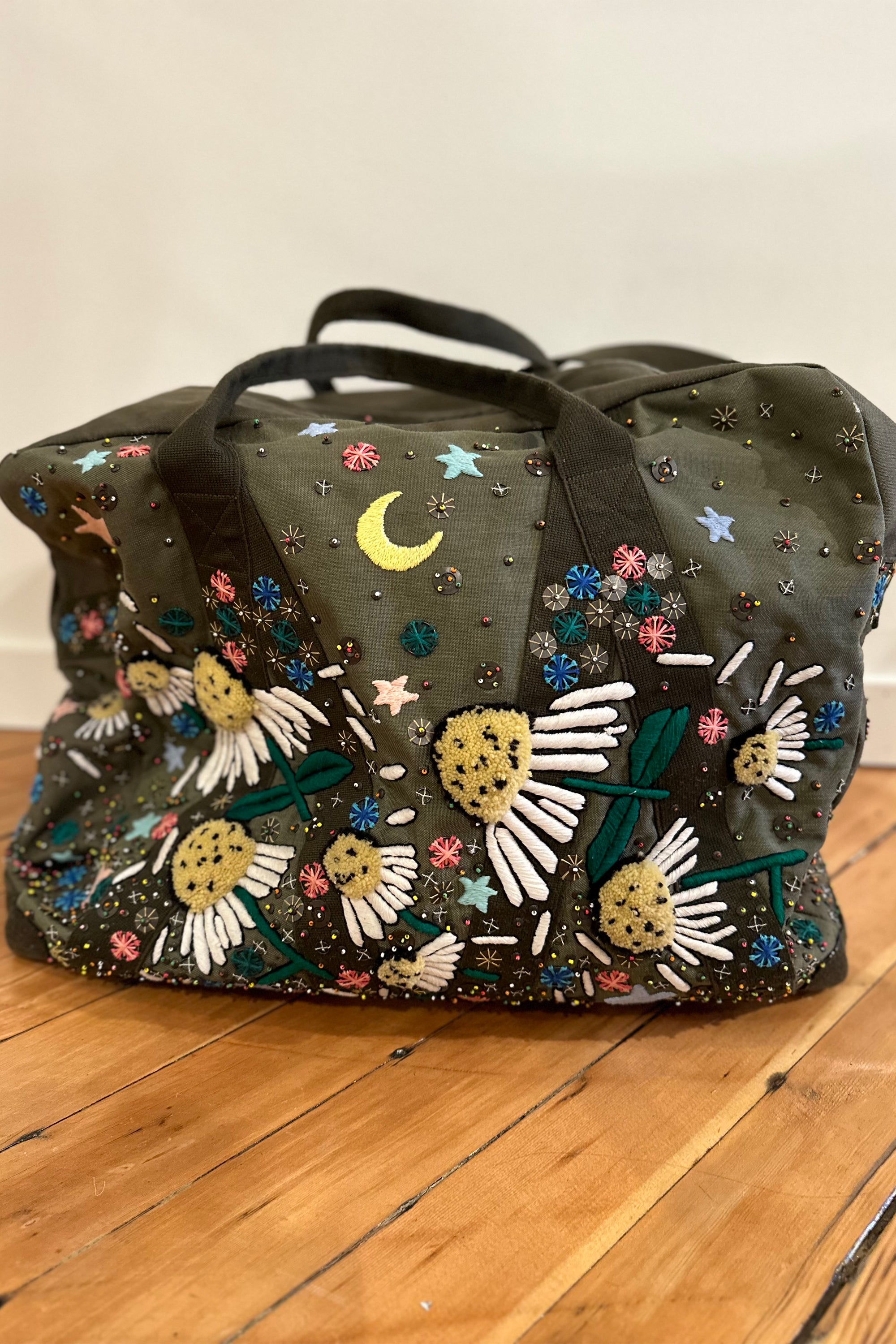 Upcycled aviator bag with embroidered embellishments, front view 