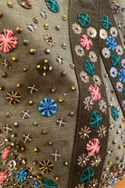 Upcycled aviator bag with embroidered embellishments, close up view 