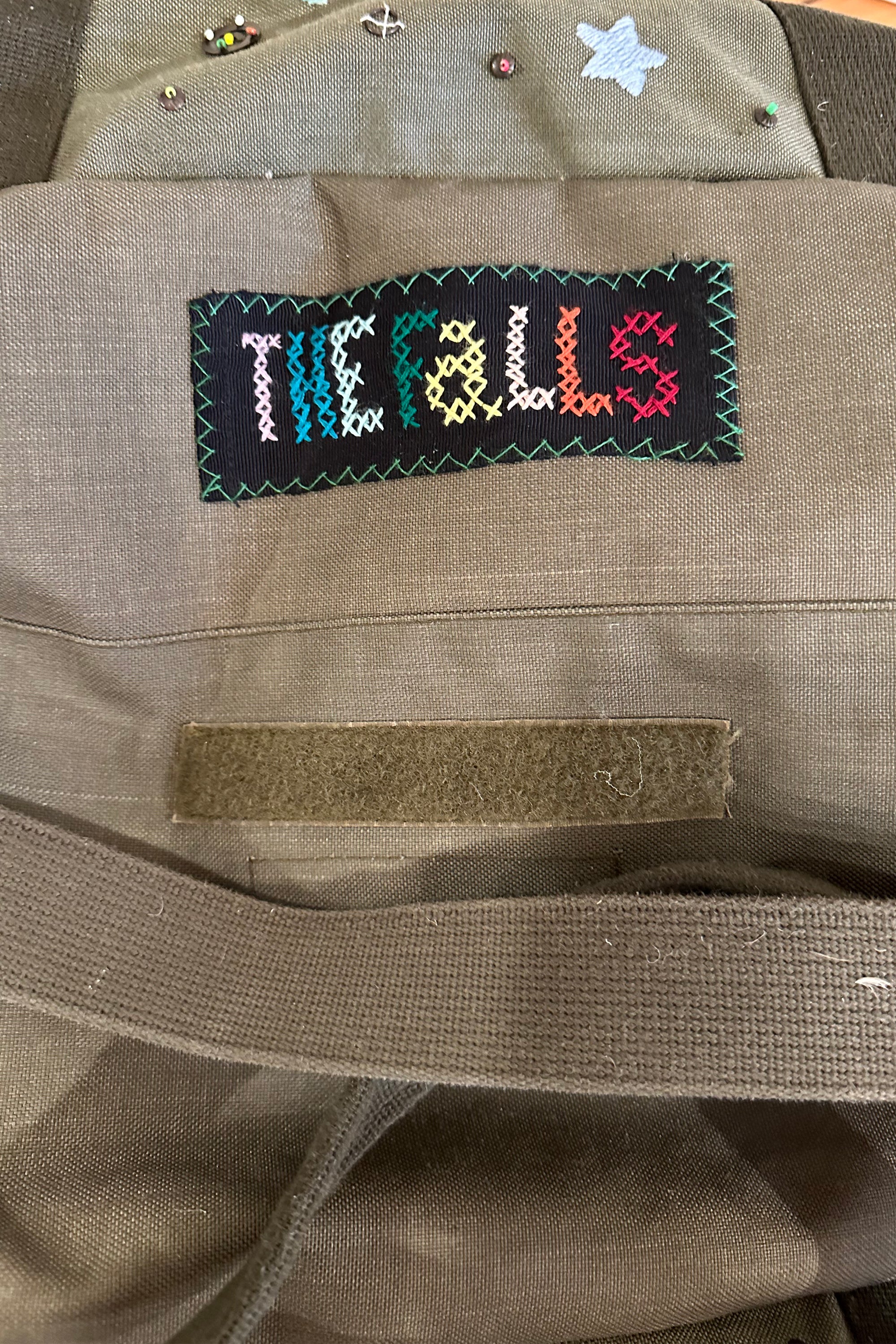 Upcycled aviator bag with embroidered embellishments, top view 